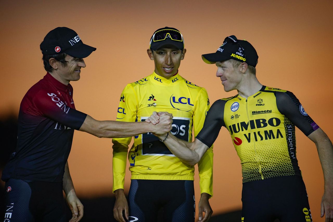 Geraint Thomas and Steven Kruijswijk shake hands in front of Egan Bernal on the Tour de France podium