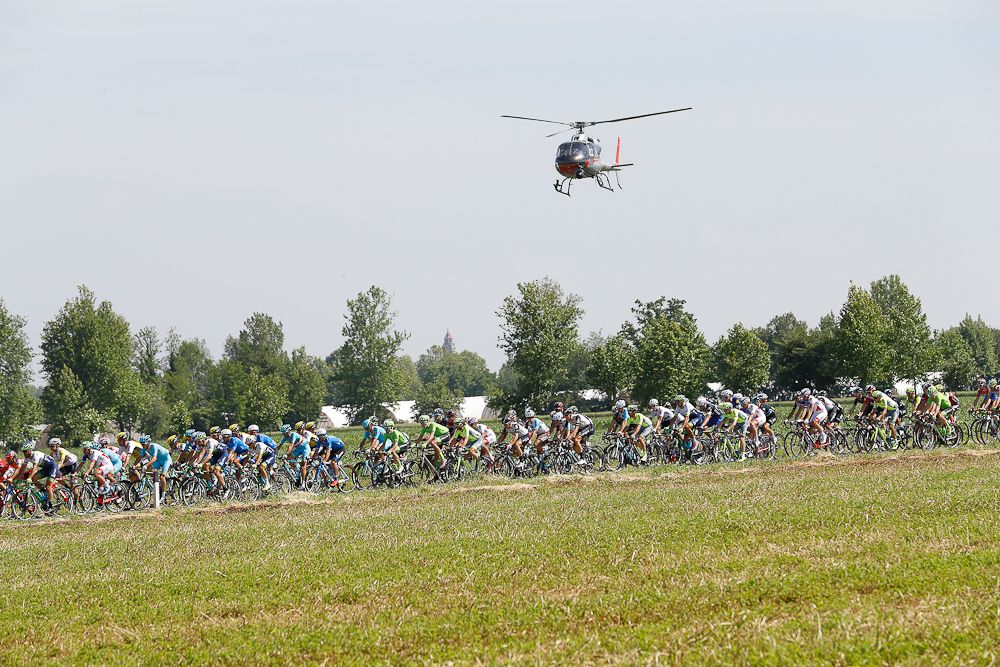 A helicoper hovers above the bunch during stage 17