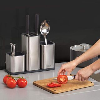 wooden chopping board with tomato and spoon