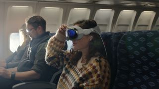 Woman wearing Apple Vision Pro on a plane