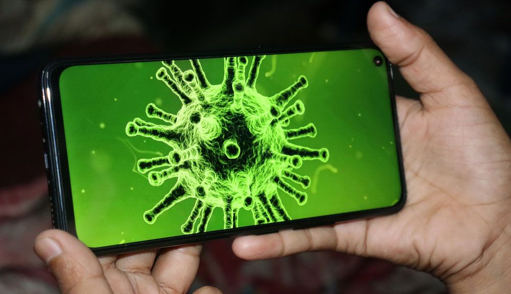 Tinted microscope image of a coronavirus displayed on an Android phone.