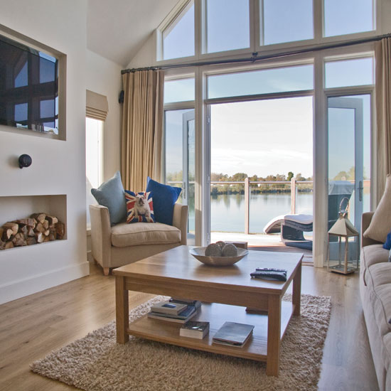 living area with glass door and wooden floor and white wall and lake view