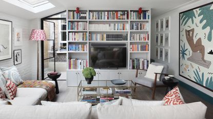 Living room showing a library of books with a TV inset into the picture