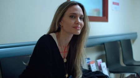 Maxine Walker (Angelina Jolie) sits in a room in Couture.