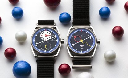 Two colourful watches side by side among coloured balls. Louis Erard x Alain Silberstein for Stephen Silver Le Régulateur (left) and La Semaine (right)