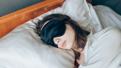 woman sleeping in a silk eye mask on