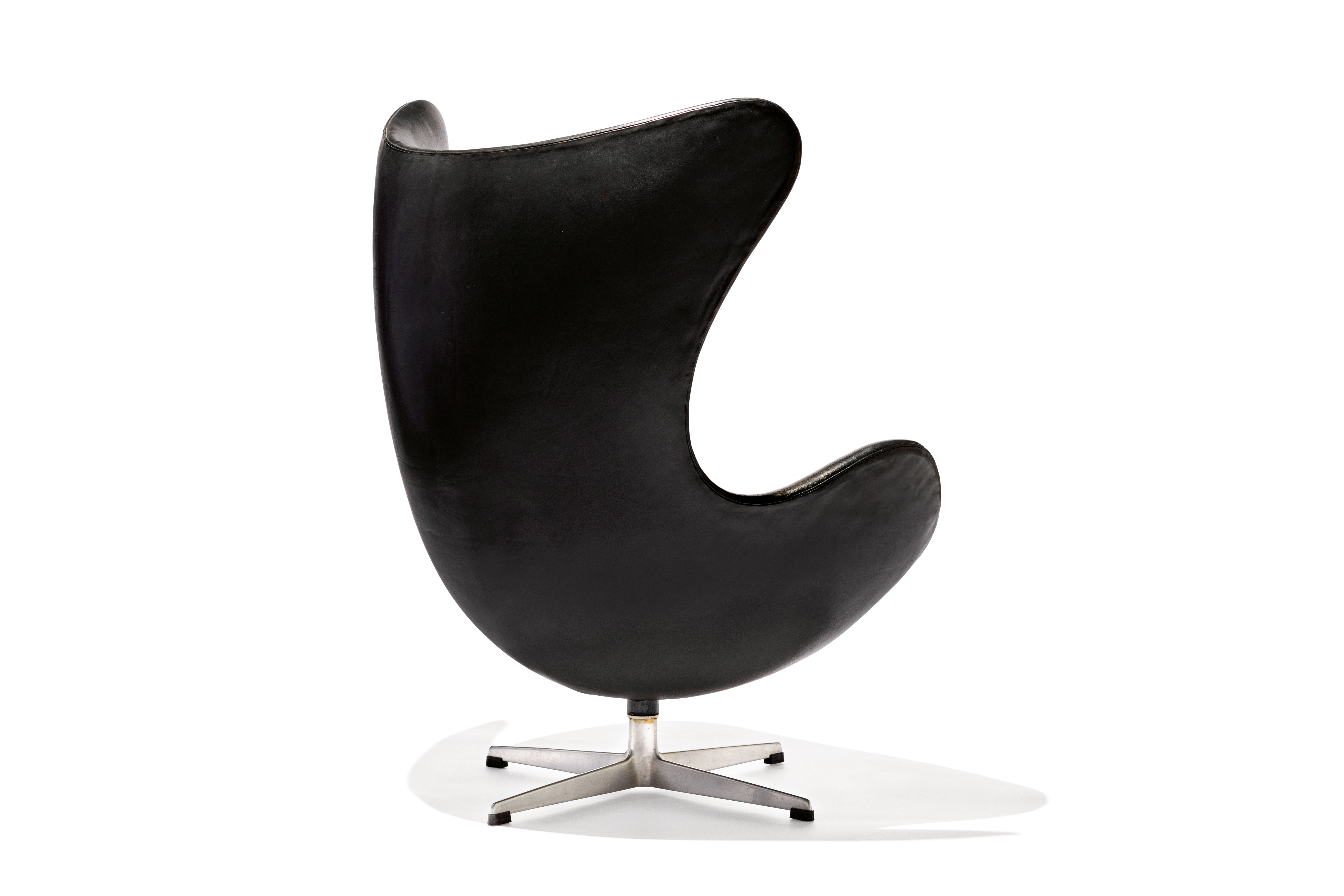 egg-shaped black swivel chair with high back 