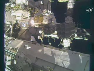 Astronaut Shane Kimbrough (bottom left) is seen moving across the exterior of the International Space Station during a Jan. 6, 2017 spacewalk to upgrade the station's power system.