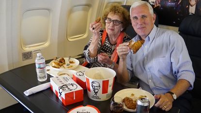Mike Pence and his mother, Nancy, dine on KFC aboard an airplane.