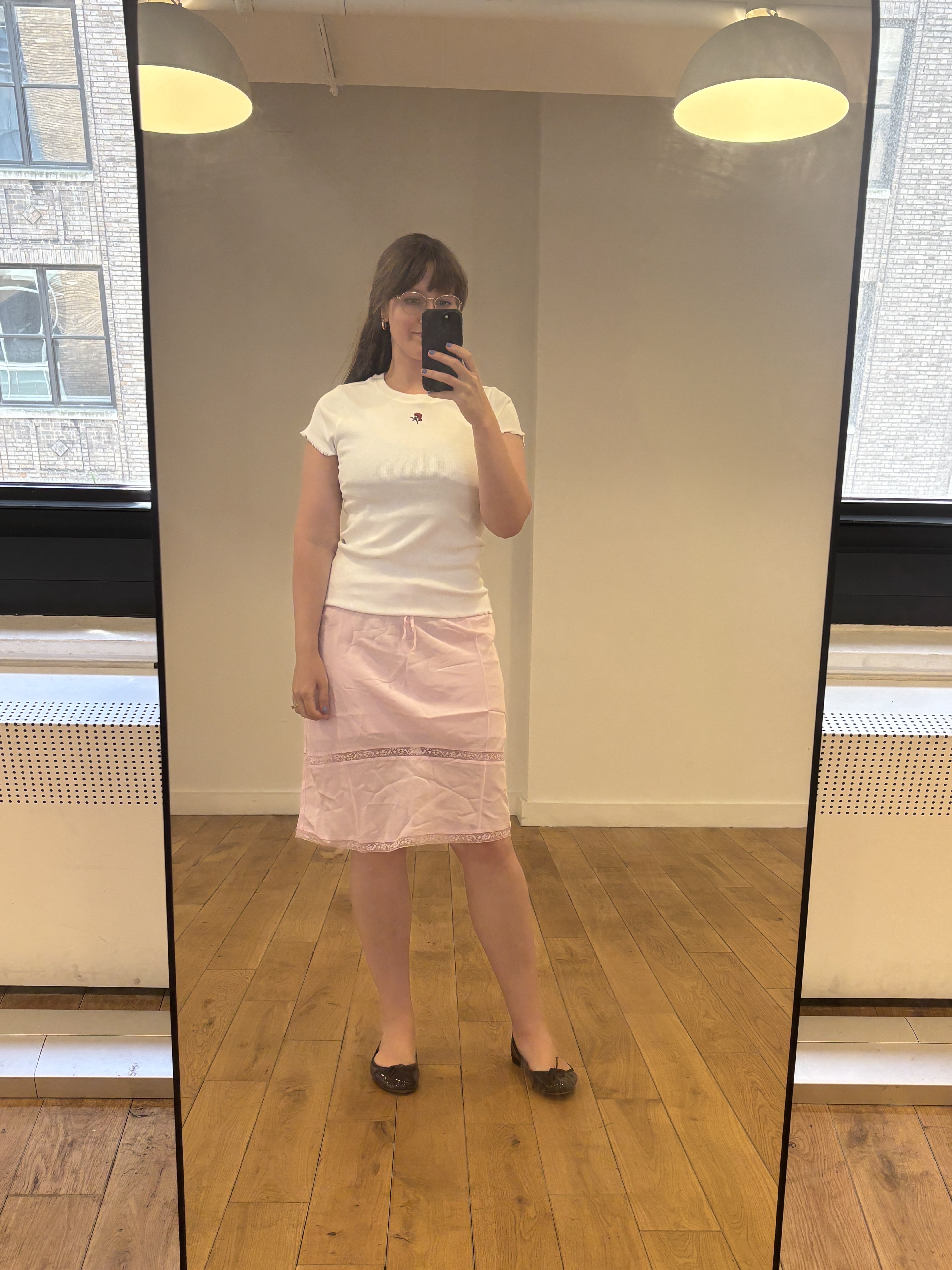 Halie LeSavage wears a t-shirt and skirt from the J.Crew and Rouje collaboration