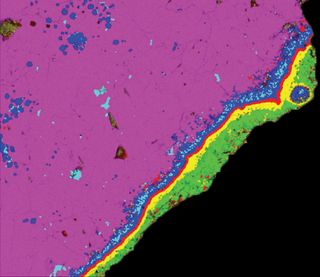 False-color compositional X-ray image of the rim and margin of a 4.57 billion-year-old calcium-aluminum-rich inclusion (CAI) from the Allende meteorite. Analysis of oxygen isotope abundances clued scientists in to the huge distances this chunk of space ro