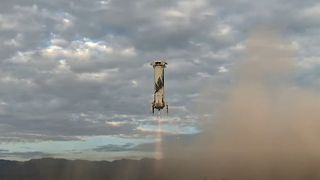 a rocket lifts off above a dusty desert