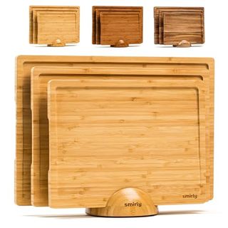 Three cutting boards in small, medium, and large sizes are stacked in a small matching wooden holder. 