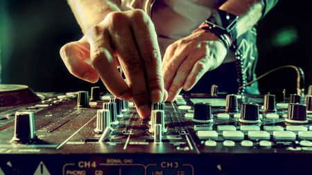 Man using a DJ mixer during a performance