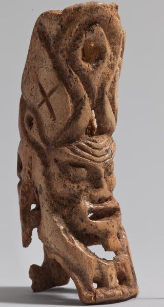 A figurine with a humanlike head and animal ears, found in the infant's burial, may represent a god that could have protected the baby from evil forces.