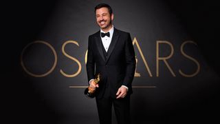 Jimmy Kimmel holding an Oscar statue
