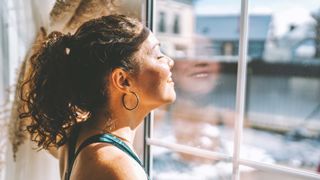 Woman enjoying the sunshine during the break between exercises