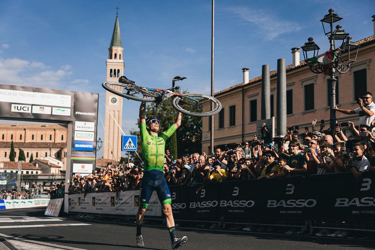 Matej Mohorič of Slovenia raises his bike in celebration