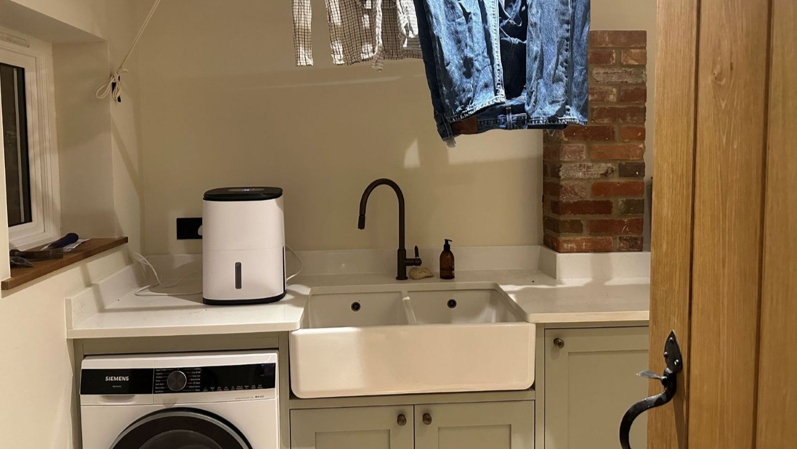 A dehumidifier on the worktop in a utility room