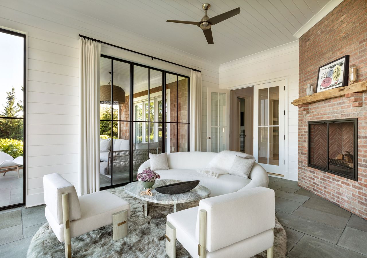 a modern sunroom with a grouped seating area