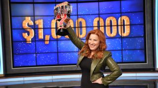 Lisa Ann Walter shows off her trophy after winning $1 million for charity on Celebrity Jeopardy!