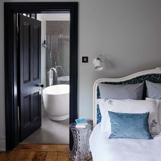 bedroom with black door with wooden flooring