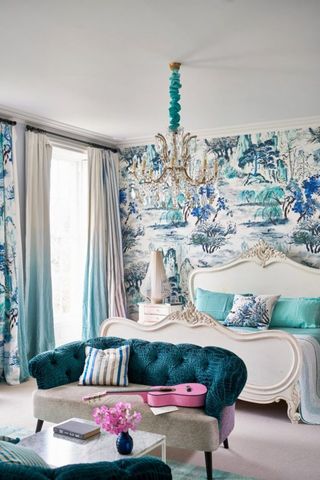 Blue bedroom with blue wallpaper and two small blue sofas