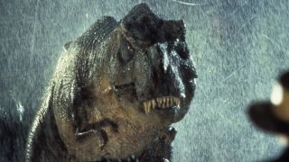 Screenshot from Jurassic Park (1993). An angry Tyrannosaurus rex in the rain.