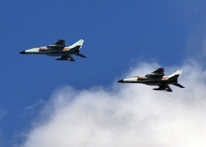 Two Chinese fighter jets fly near their base in Shanghai