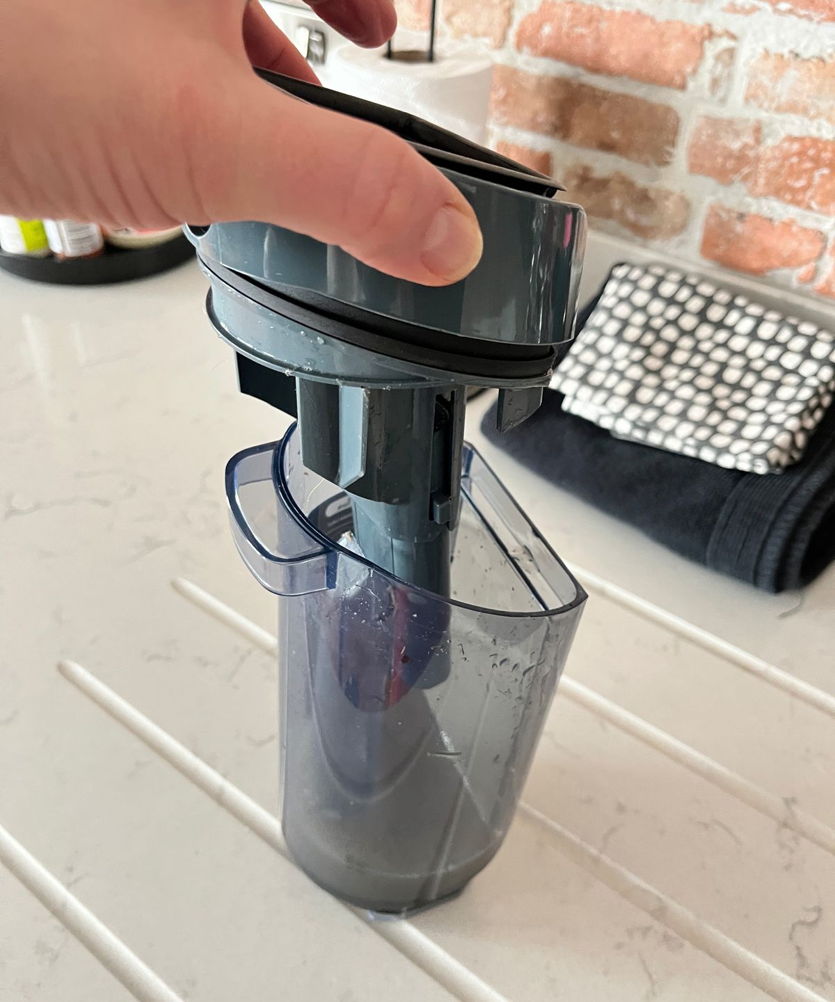 dirty water container of floor cleaner being emptied