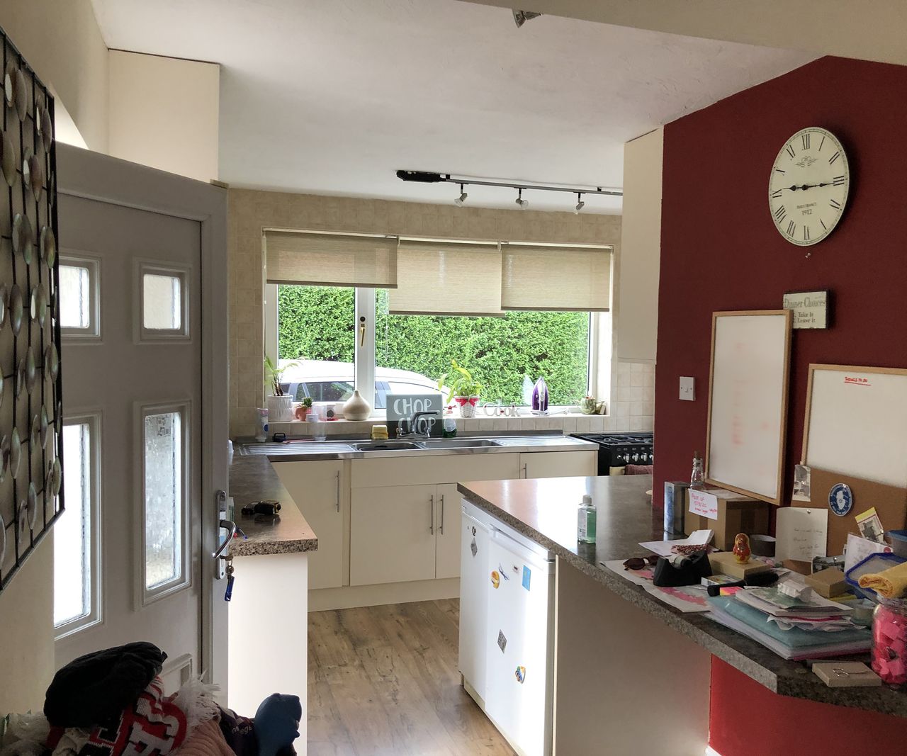 The before image of a house which is about to be renovated and extended. A narrow kitchen with light cabinets