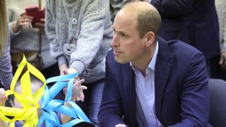 Prince William, Prince of Wales listens at an accommodation centre during his visit to Poland