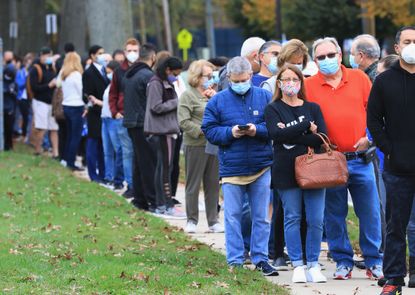 Residents wait in line for the opening of an early voting location at the Mid-Island Y Jewish Community Center on October 24, 2020 in Plainview, New York.