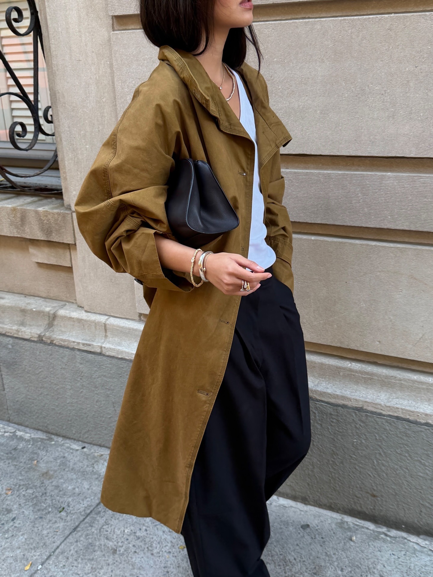 Mimi wearing The Row Peggy Clutch.