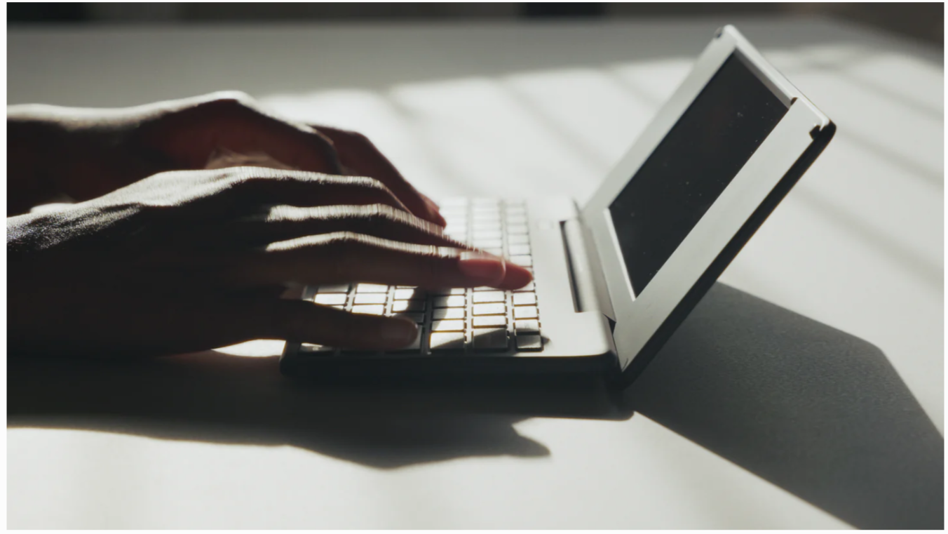 Hands typing on Pomera DM250Us in profile