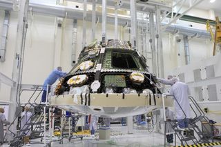 Engineers install the heat shield for NASA's Orion spacecraft. Image uploaded June 5, 2014.