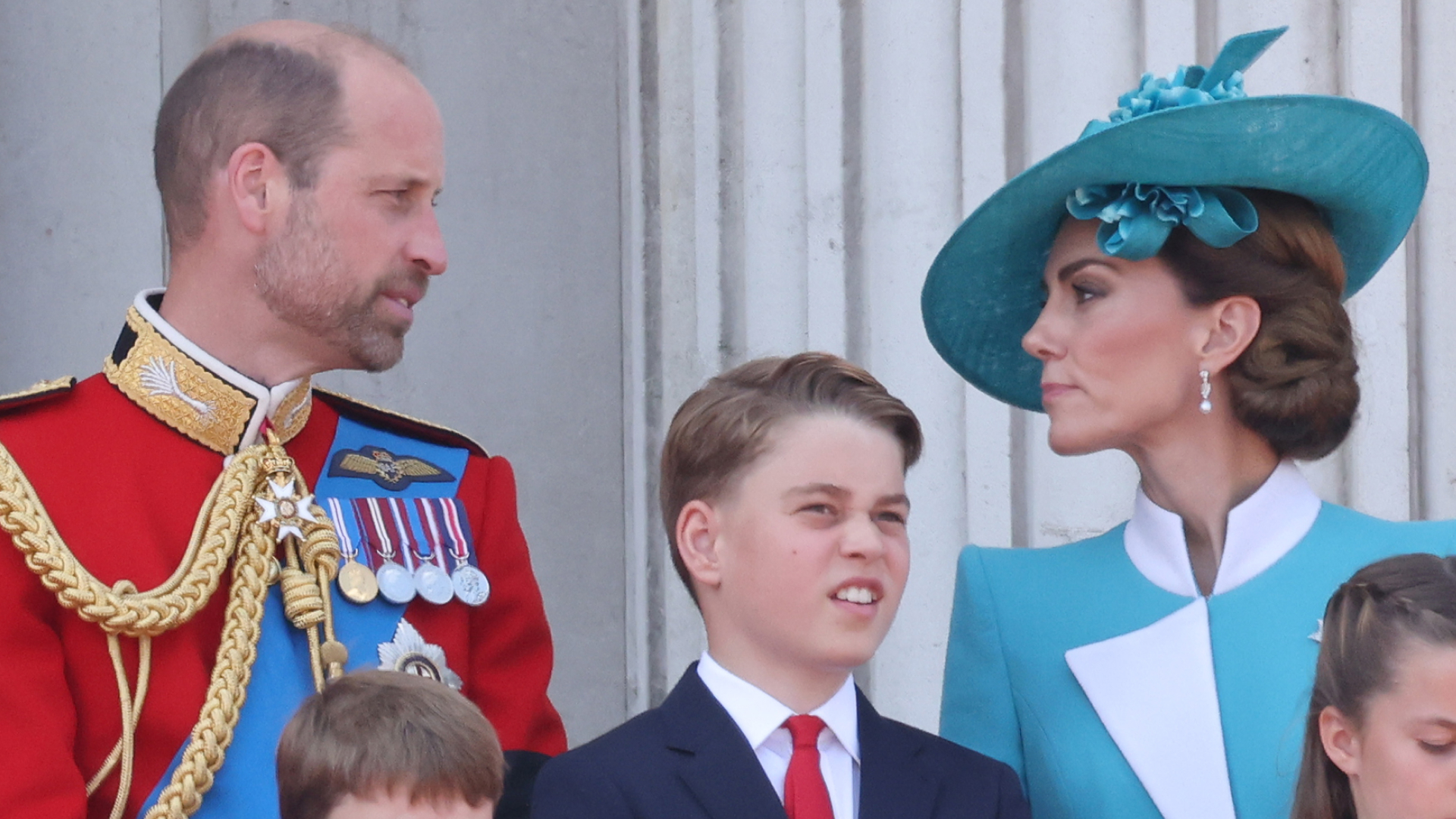 Kate Middleton and Prince William talking on the Buckingham Palace balcony at Trooping the Colour