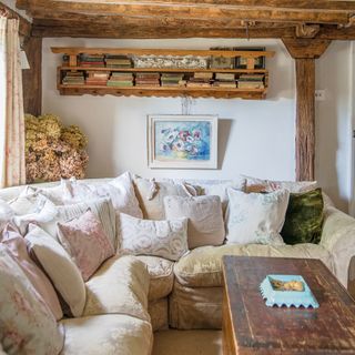 Beamed cottage living room with shabby chic corner sofa and mixed scatter cushions