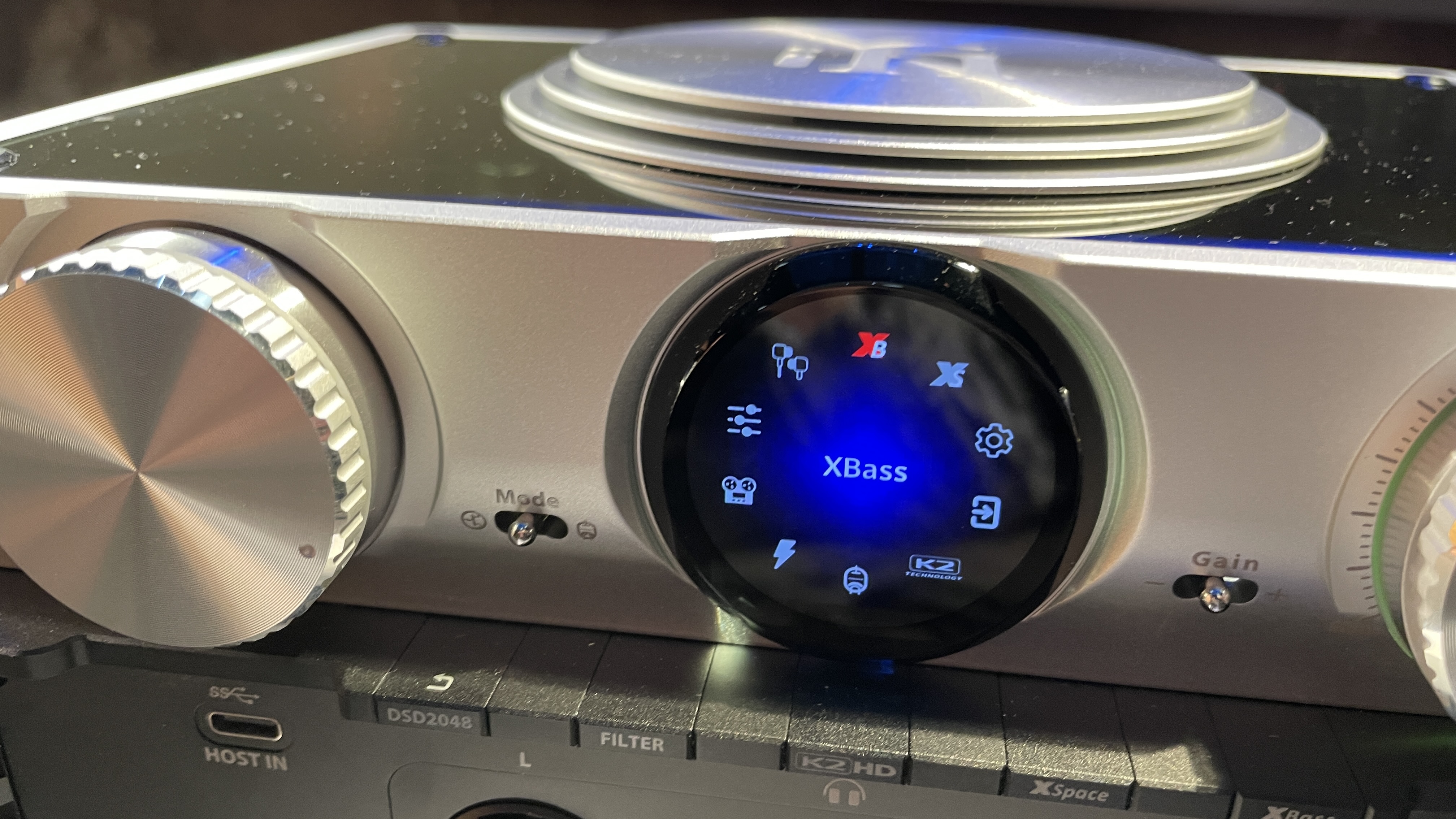 The formidable iFi iDSD Phantom in Tower Bridge, London, used with headphones and illuminating the front panel 