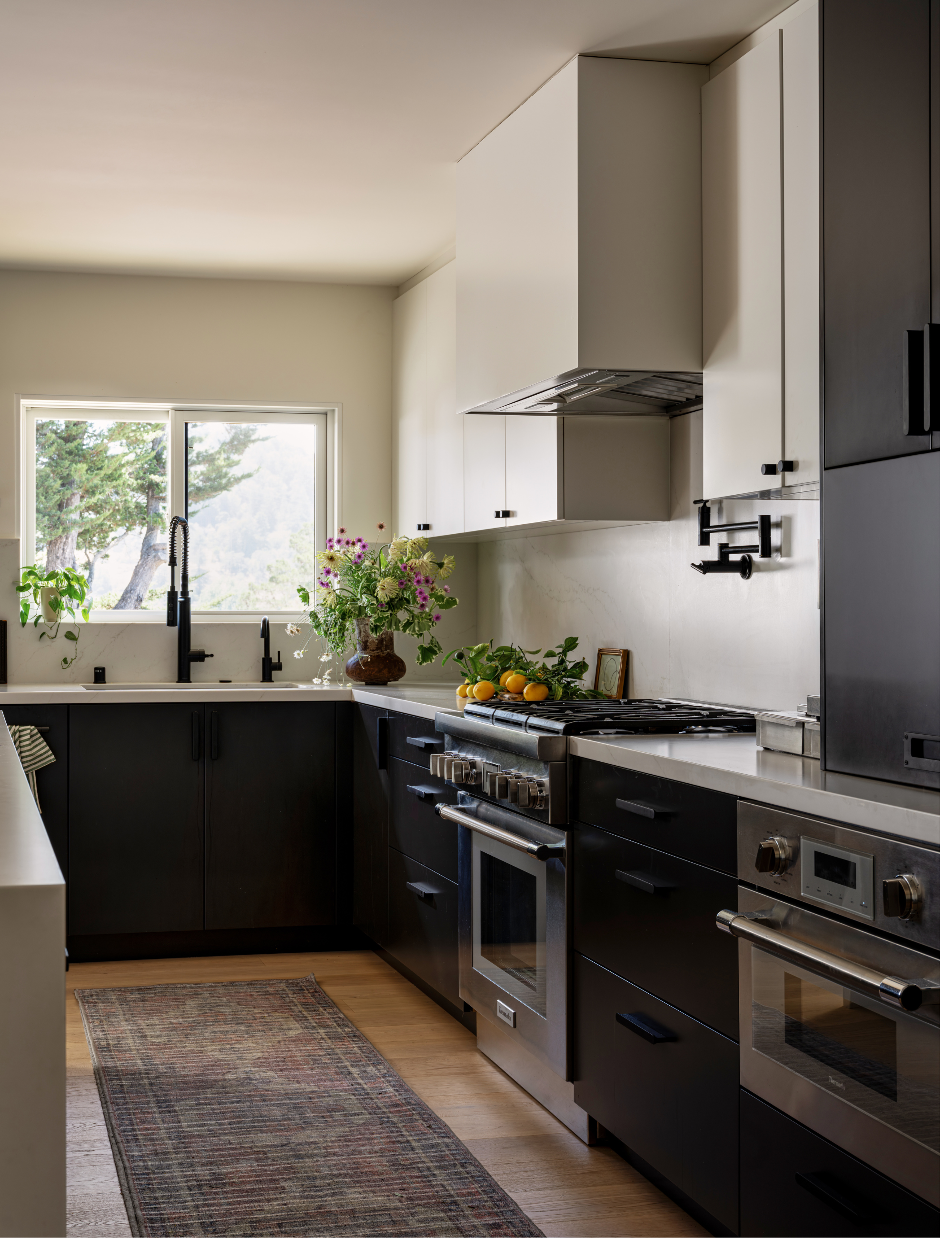 Small neutral kitchen featuring sleek cabinetry and a hidden appliance garage