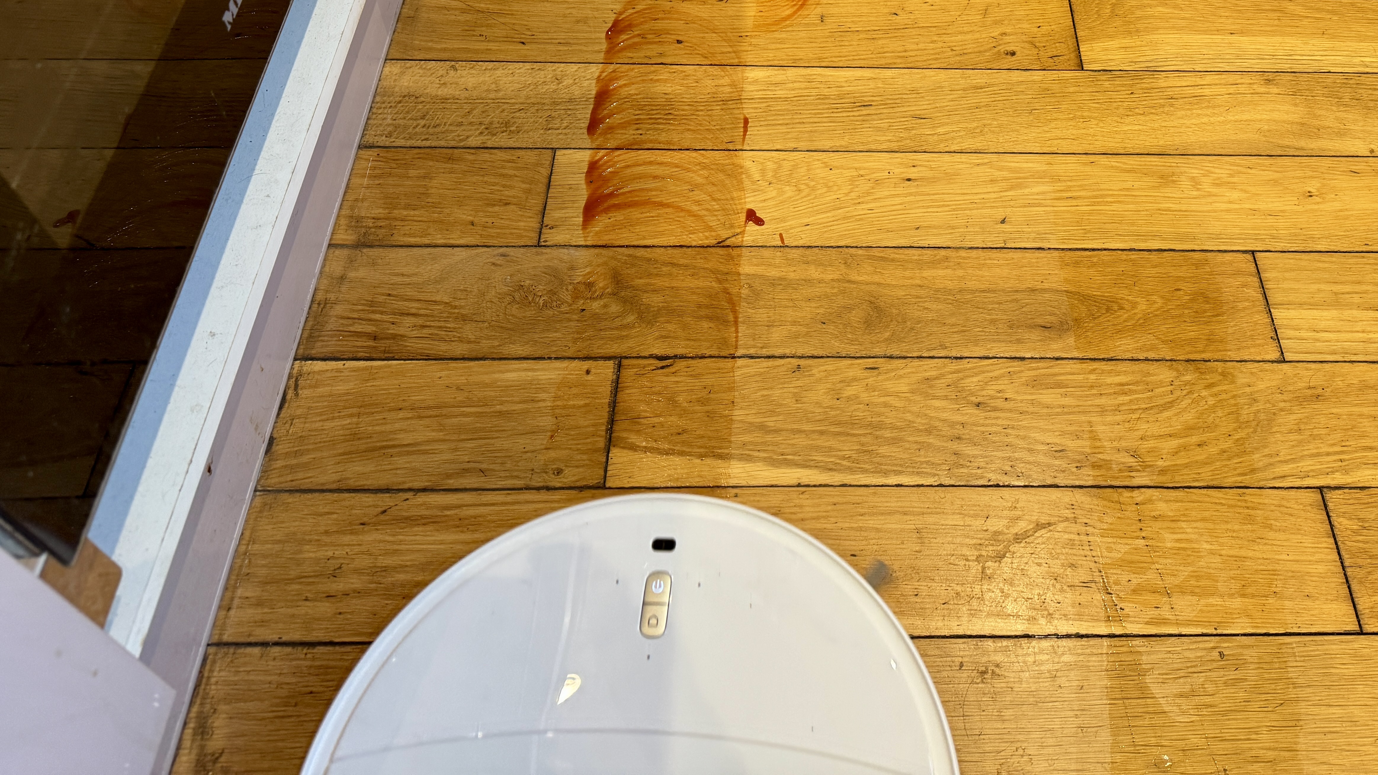 Roborock Qrevo Curv 2 Pro cleaning a spillage from a hard floor
