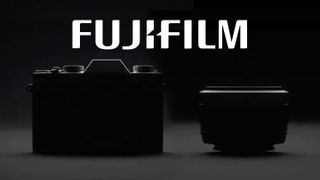 Silhouetted image of a Fujifilm camera and lens with the Fujifilm logo floating above