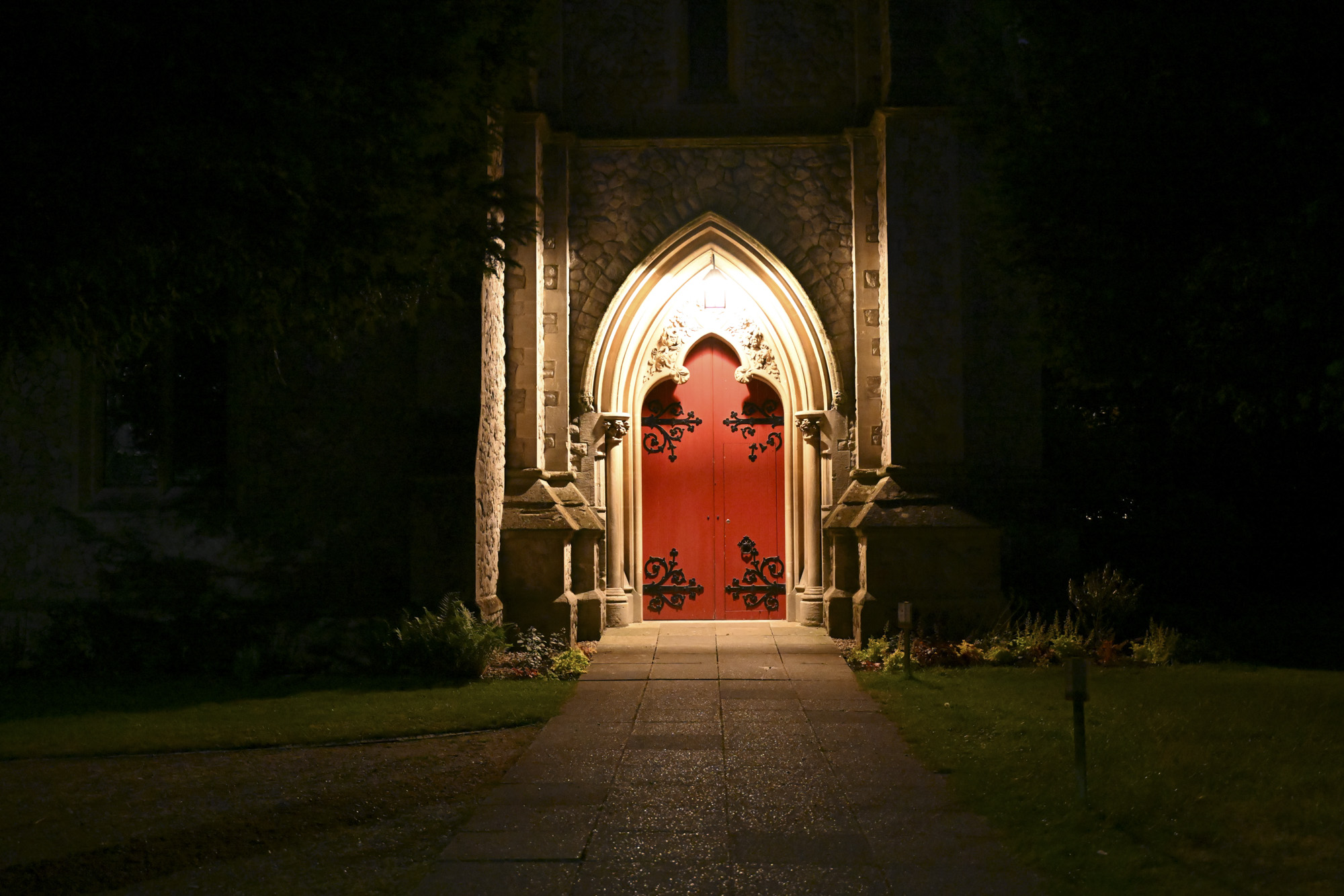 low light of a bright red old door at night