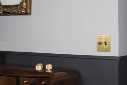 A light switch in gold