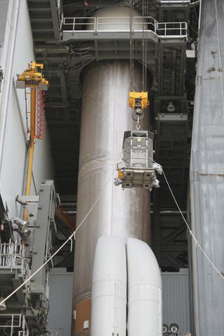 A view of Curiosity's MMRTG being lifted into place before launch in 2011.