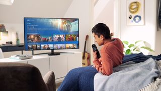 Sky Q box being used by a male teenager to watch TV in his bedroom