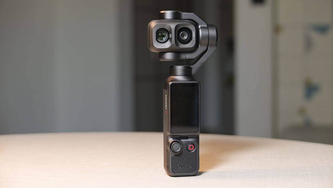 DJI Osmo Pocket 4P vlogging camera on a white desk in modern room