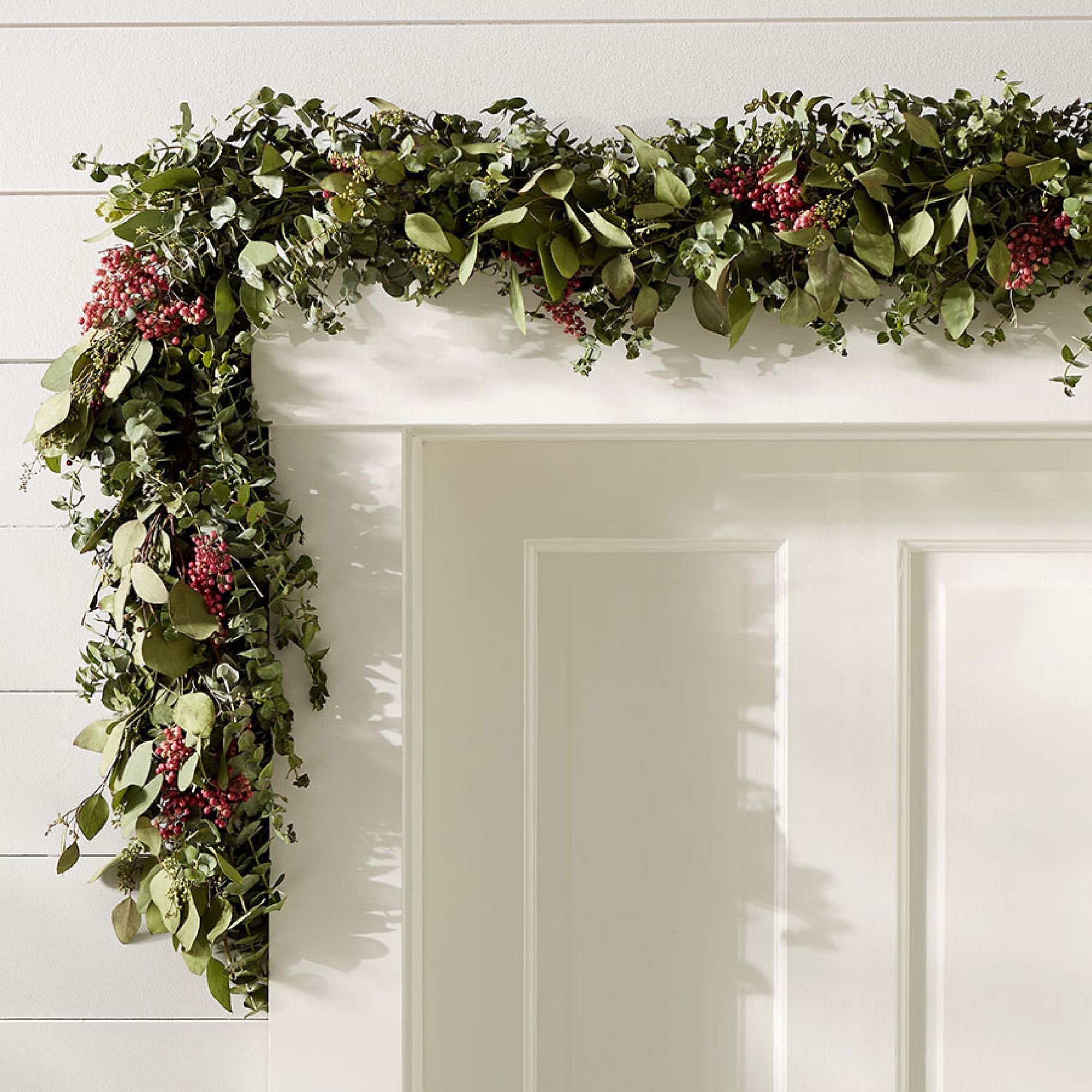 Eucalyptus and berry garland above a doorway