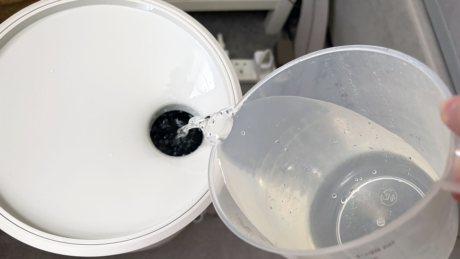 A close up of water from a jug being poured into an Orion Control Tower