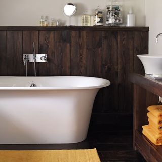 Bathroom with bathtub and wooden flooring
